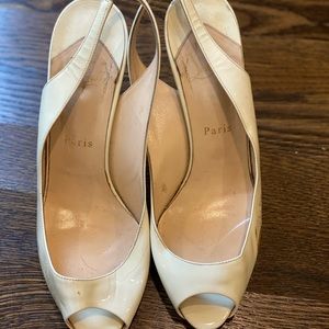 Christian Louboutin cream patent leather heels.